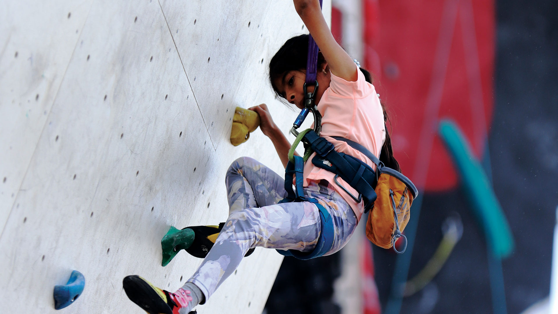 A young climber on a rock wall