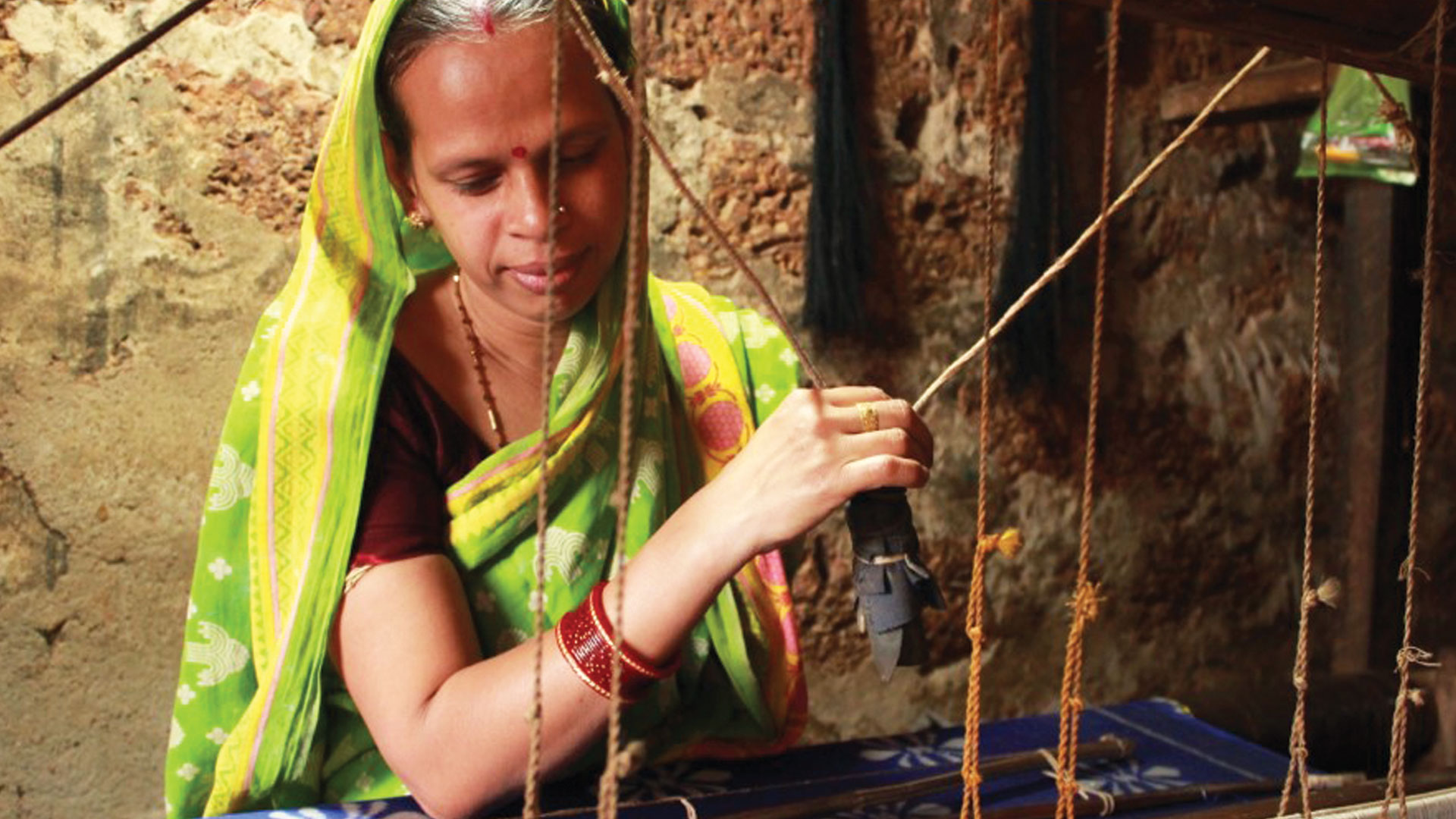 Women at work crafting silk sarees