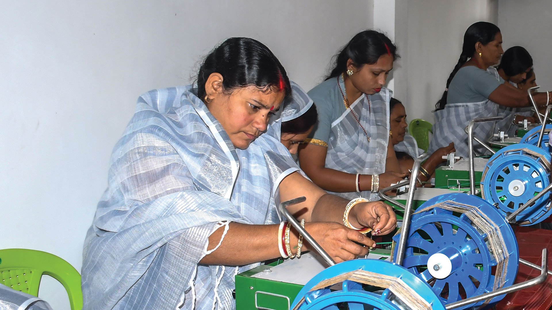Women using a mechanised charkha
